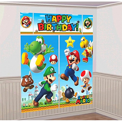 A colorful "Happy Birthday" banner featuring characters from the Super Mario Brothers series, including Mario, Luigi, Yoshi, and others, is displayed as part of the Amscan Super Mario Brothers Kids Birthday Party Decoration Scene Setters w/Photo Props on a room's wall.
