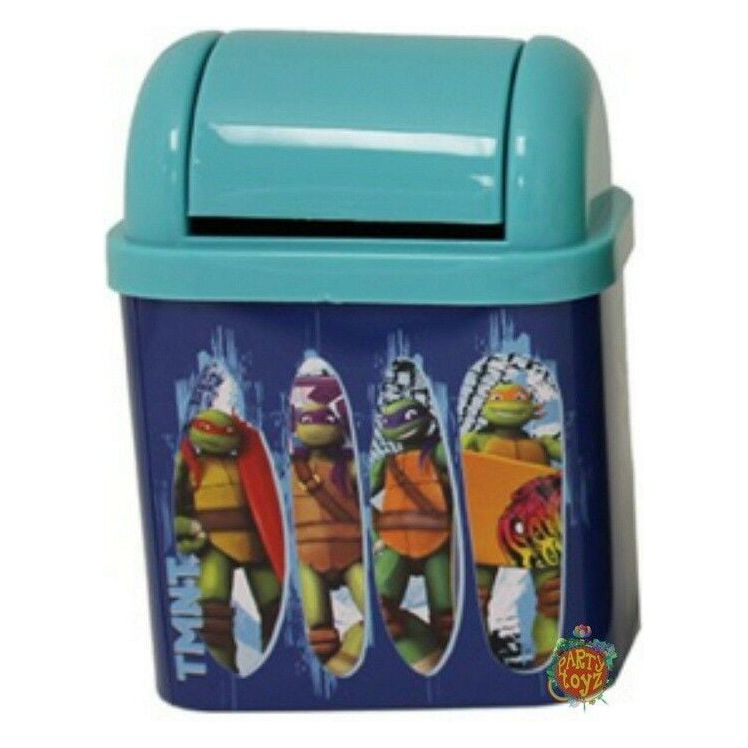 A small, blue Teenage Mutant Ninja Turtles Desktop Waste Bin Tin with a flip-top lid, decorated with colorful graphics of the Teenage Mutant Ninja Turtles sewer surfing in action poses. Made by Tin Box Company.