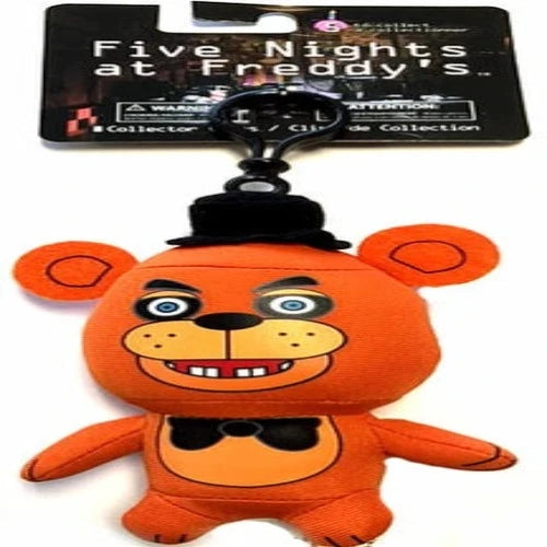An orange plush keychain featuring the Five Nights At Freddy's Collector Clip Figure - Freddy Fazbear from Sanshee, with a smiling face, large eyes, and a black bow tie, attached to a collector clip and key ring.